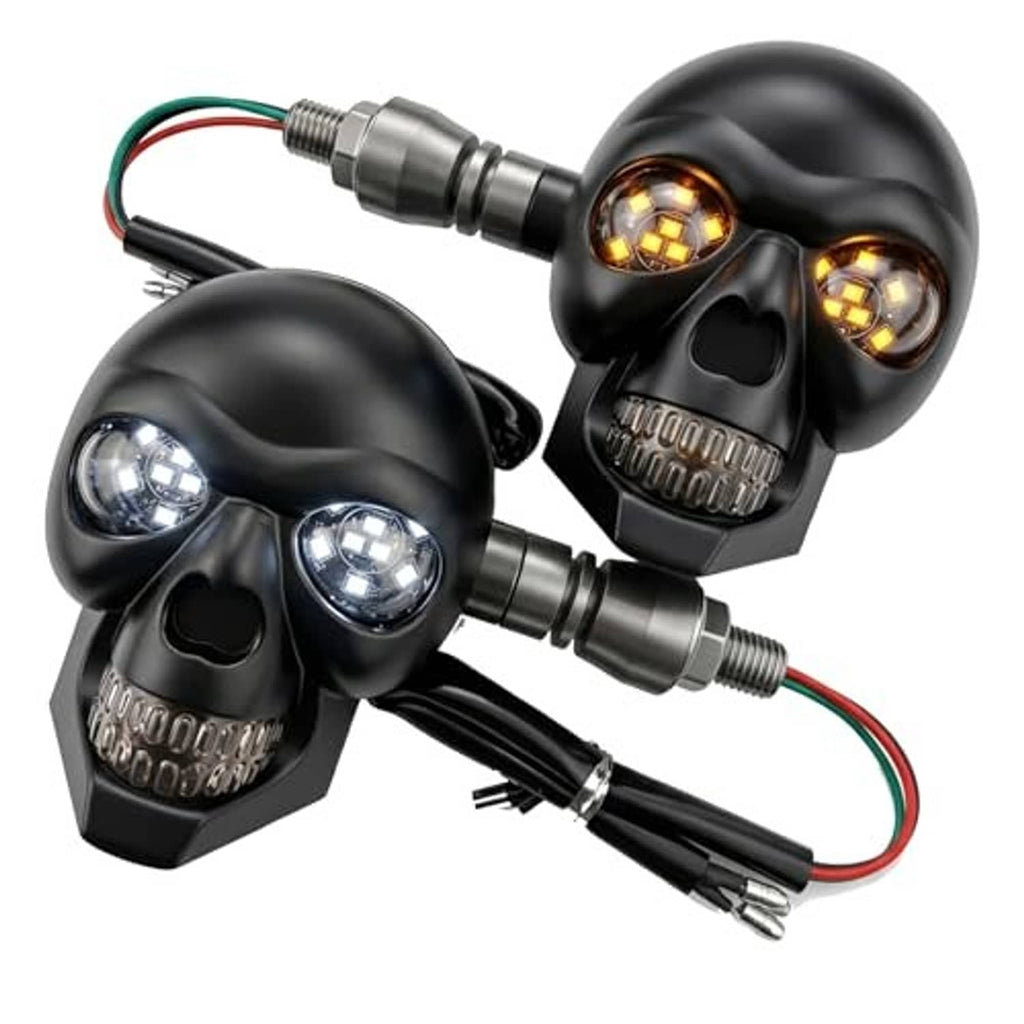 Pair of black skull motorcycle LED turn signal lights with amber lenses and wiring connectors