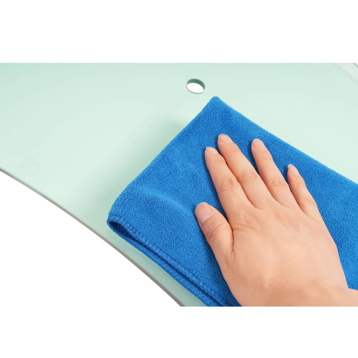 Right side cab door glass being wiped with a blue microfiber cloth