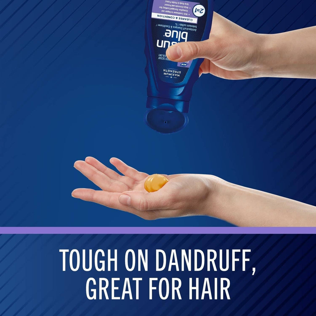Hands dispensing shampoo from a blue bottle onto the palm