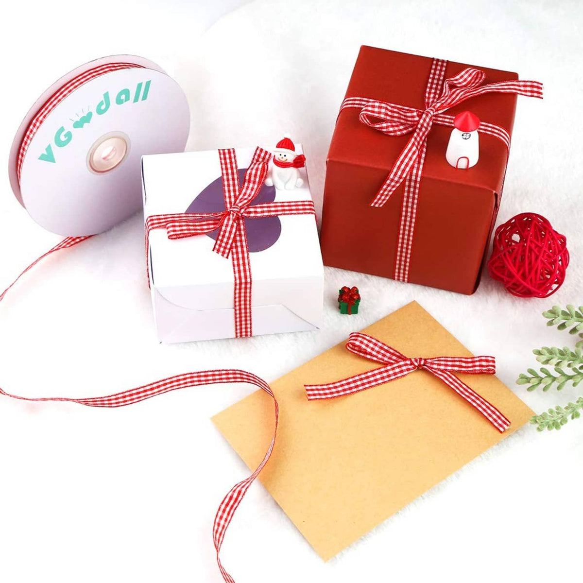 Red and white gingham ribbon spool with loose ribbon strips and tied bows, thin craft ribbon