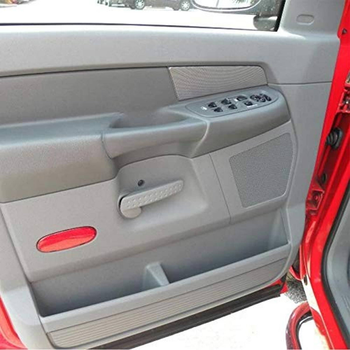 Grey car door window switch panel installed with window buttons and door lock controls