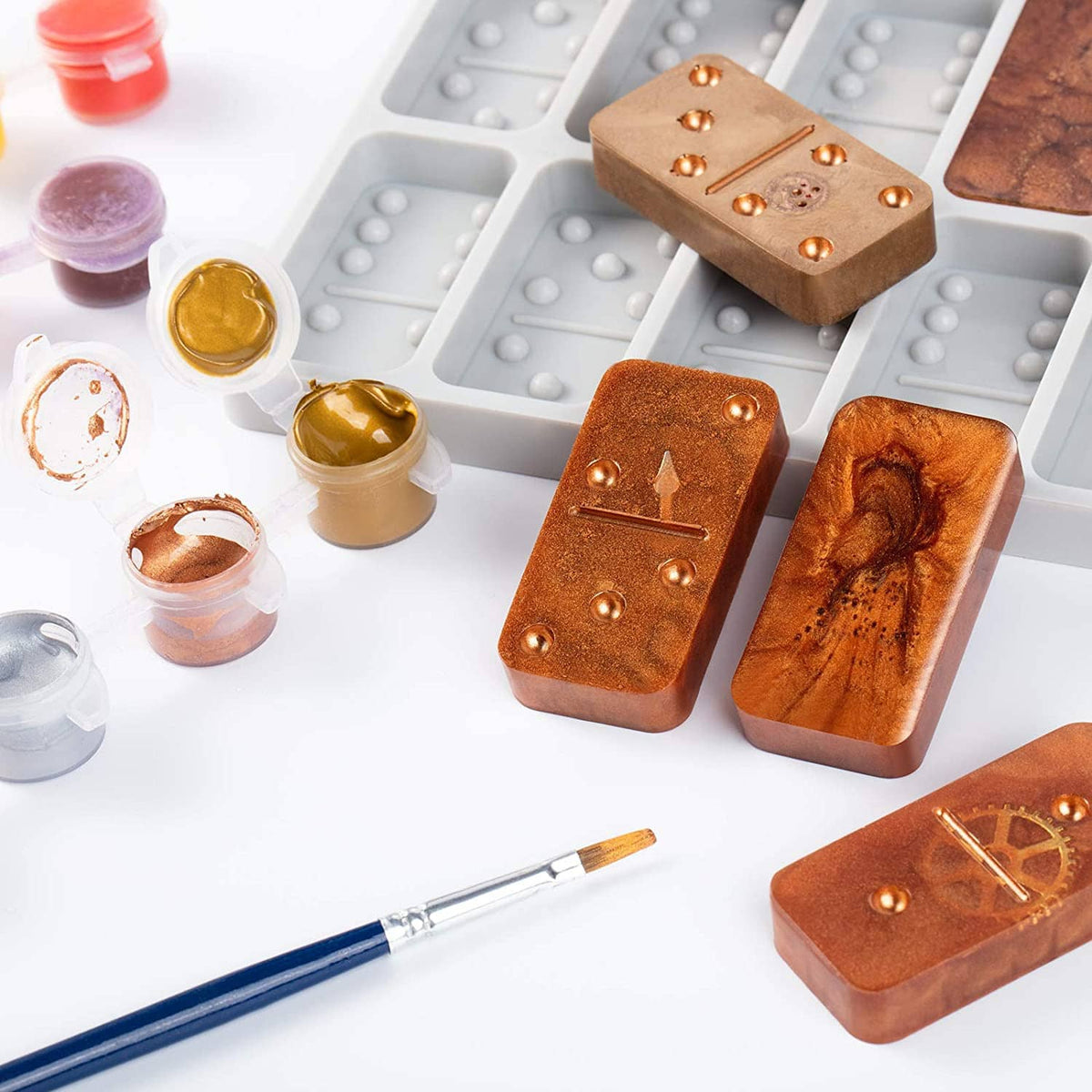 Round thick domino silicone mold with painted brown domino pieces and small casting materials