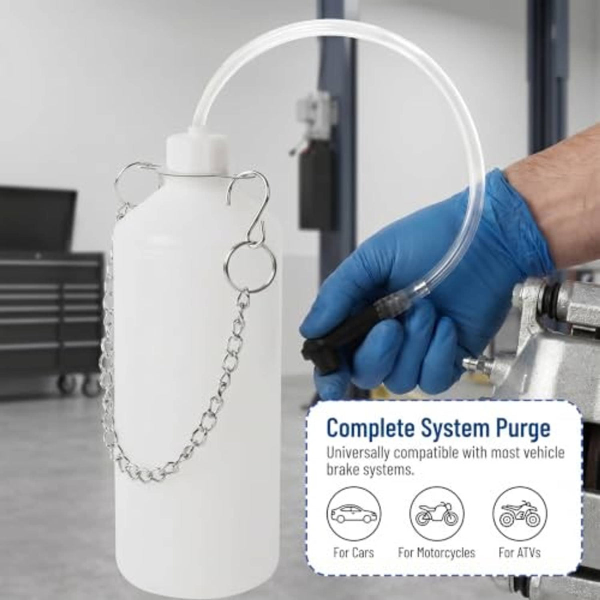 Brake bleeder bottle with clear hose and black pump, shown with gloved hand