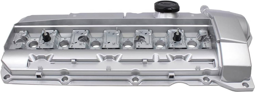 Silver valve cover top view with oil cap, molded channels, and mounting bosses