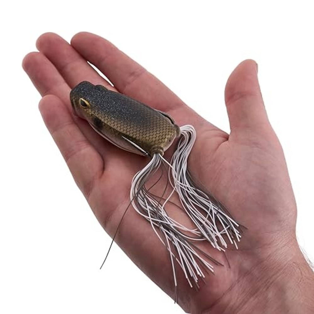 Frog popping lure in hand, dark olive body with white skirt and red mouth