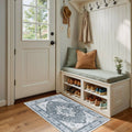 Small rectangular washable area rug with grey, white, and beige floral medallion pattern