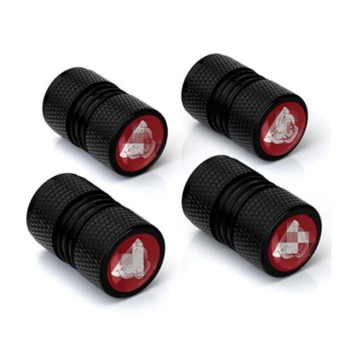 Four black textured valve stem caps with red round emblem, threaded end visible