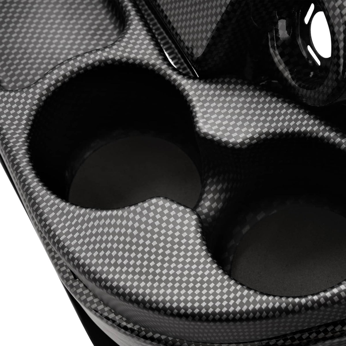 Close-up of black carbon fiber style dashboard cover with contoured cup holder openings