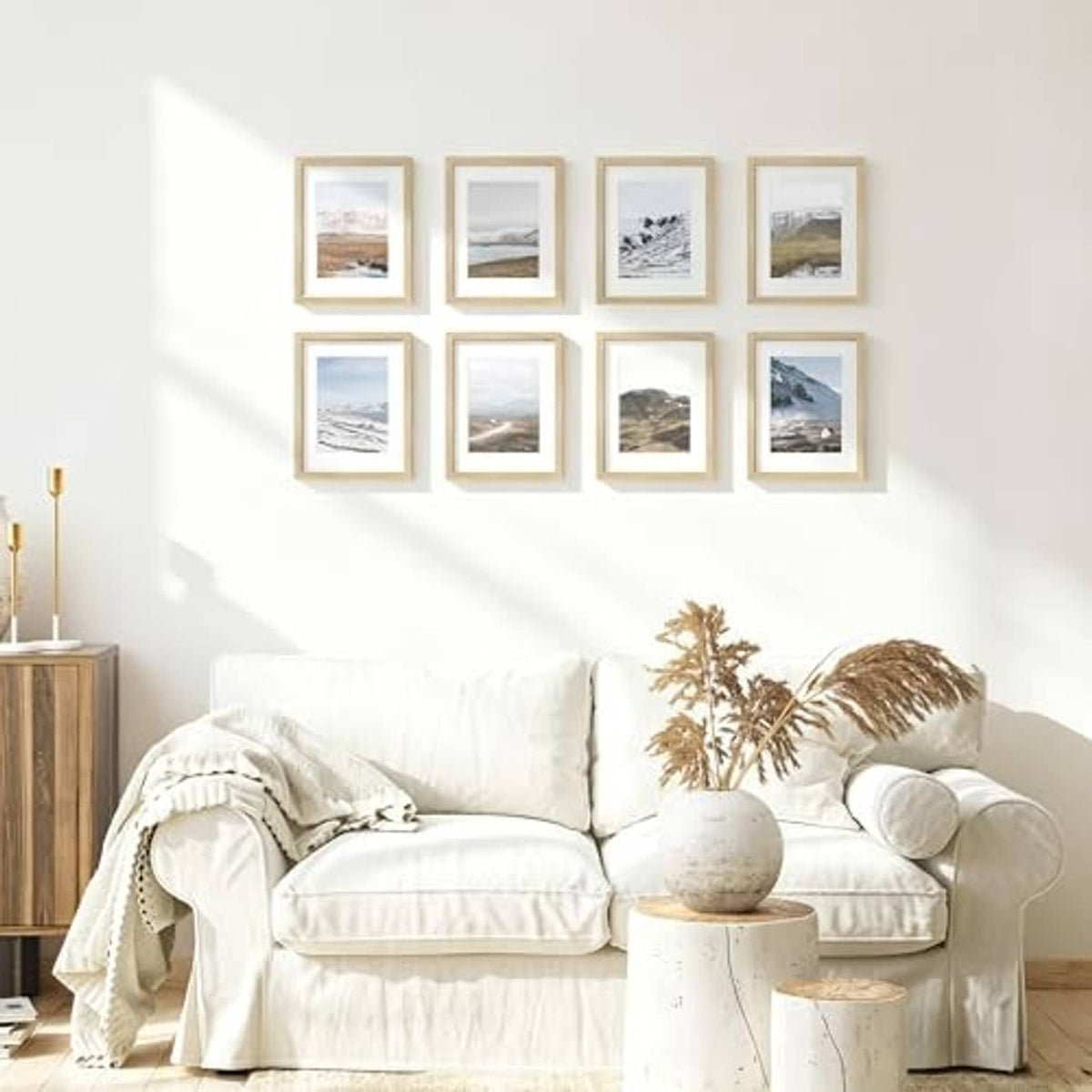 Natural oak photo frame set with several 8.5x11 frames, arranged above a sofa.