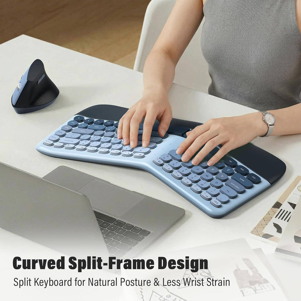 Hands typing on a blue split ergonomic keyboard with dark wrist rest