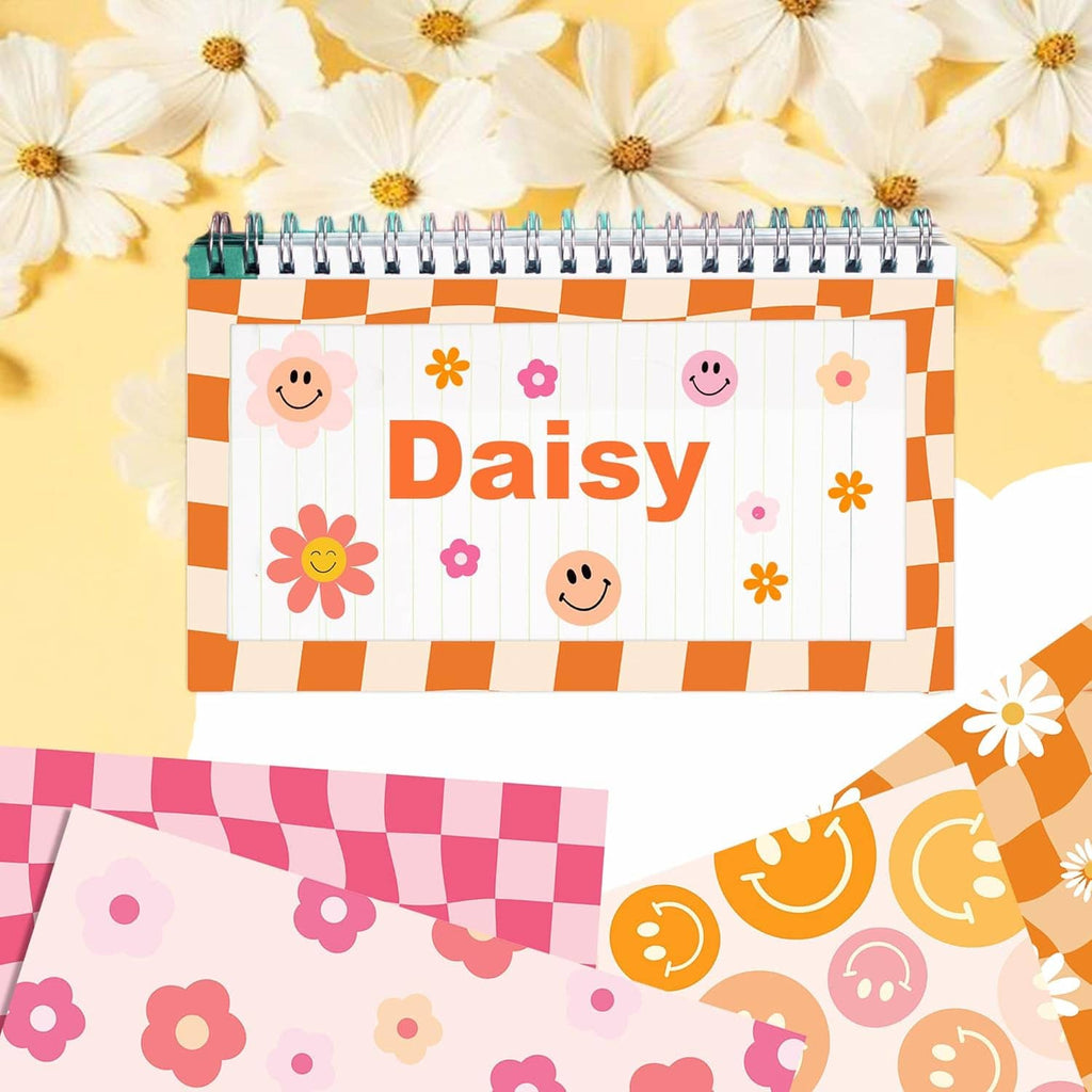 Scrapbook paper with orange Daisy title on white label and smiley flower icons