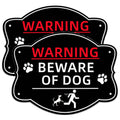 Black warning sign reading “WARNING” and “BEWARE OF DOG” with paw icons