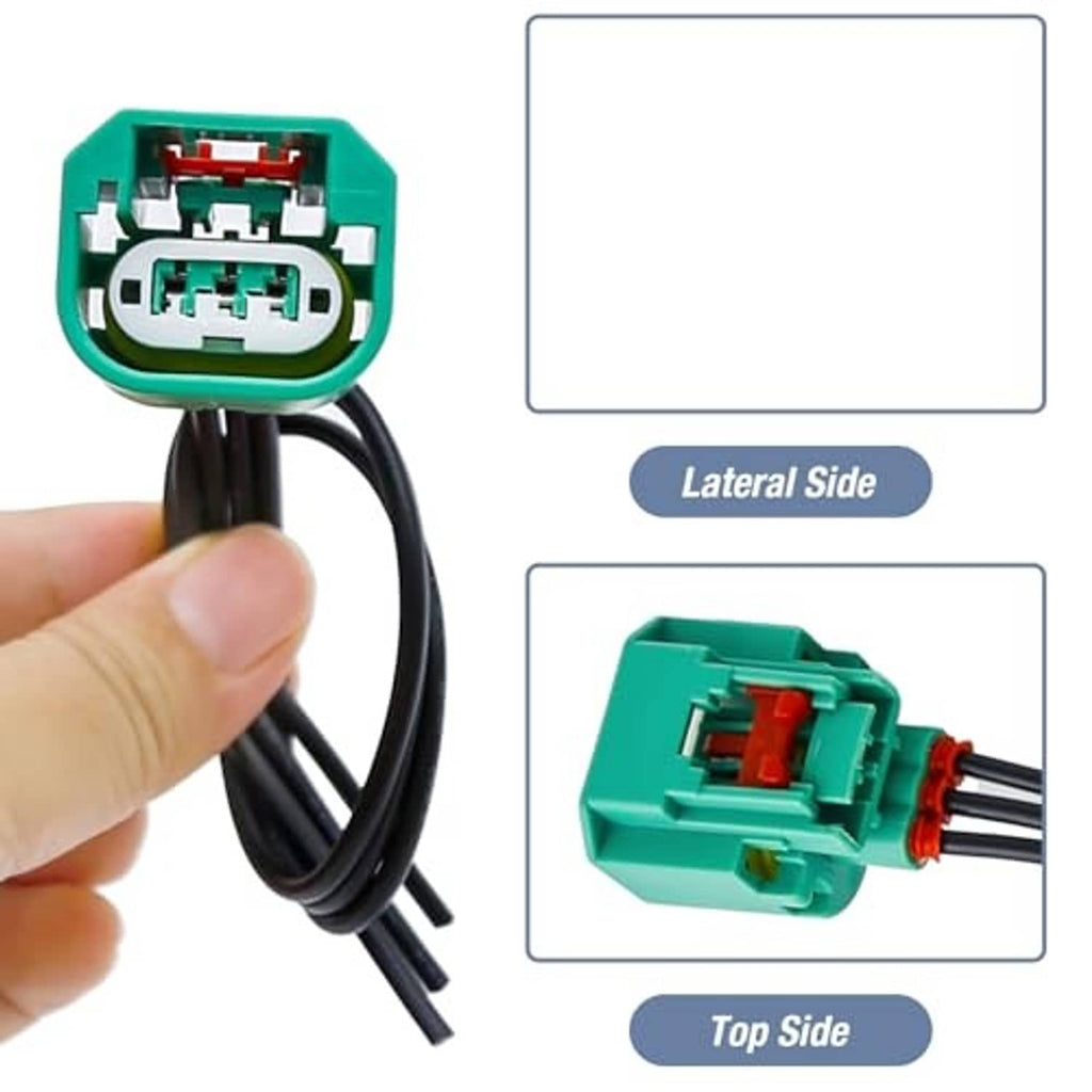 Green headlight connector plug held by hand with black wire harness and terminal view