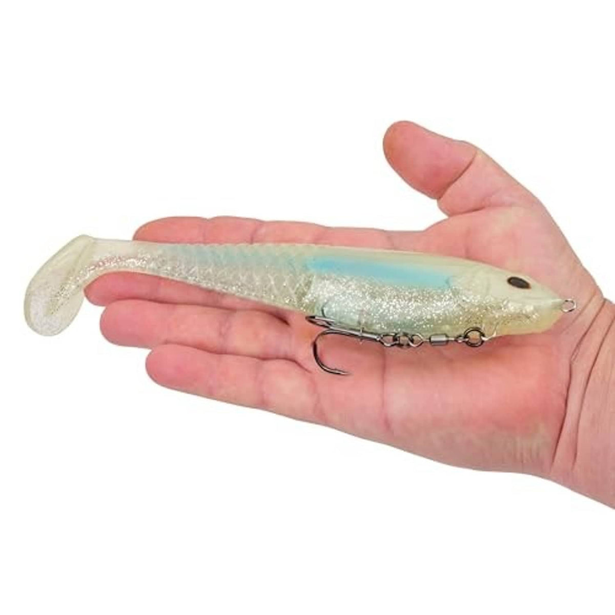 Soft plastic swim bait in hand, light green pearl body with treble hook
