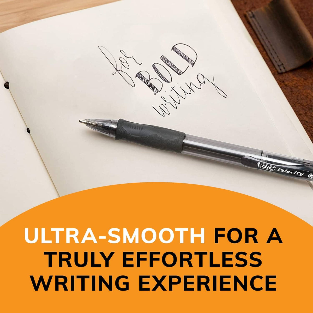 Retractable black ballpoint pen lying on an open notebook with handwritten ink.