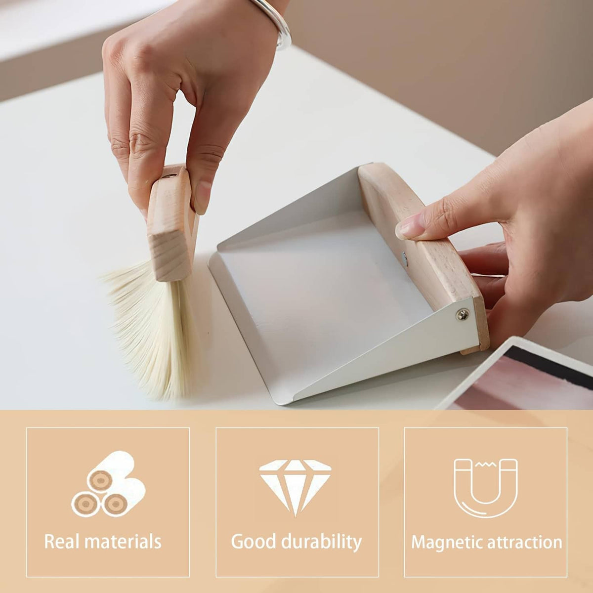 Mini beechwood dustpan and brush set held in hands for tabletop cleaning