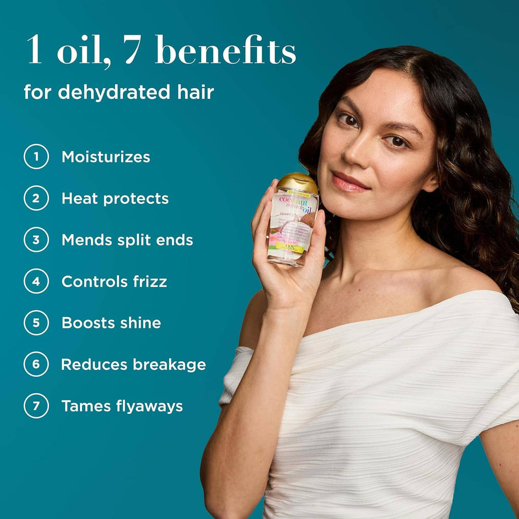 Woman holding coconut miracle oil penetrating hair oil bottle; dark wavy hair, white top