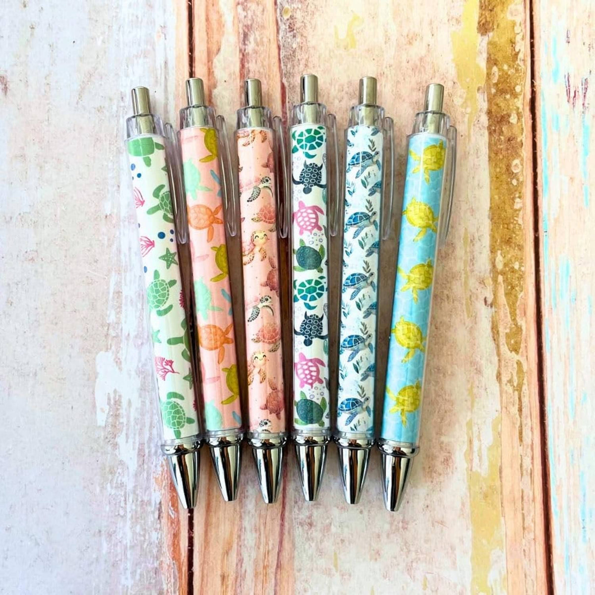 Set of 6 clear-barrel turtle-print pens with silver tips