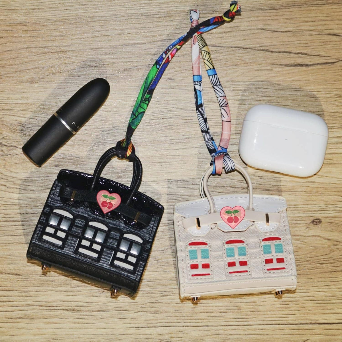 White mini backpack keychain pouch with heart charm and colorful window print.