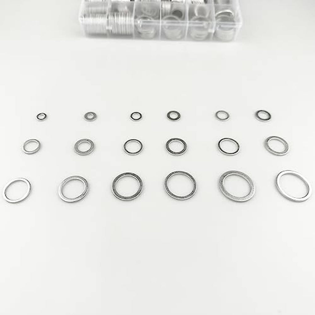 Mixed sizes of silver aluminum oil drain plug gaskets (washers) spread out for comparison