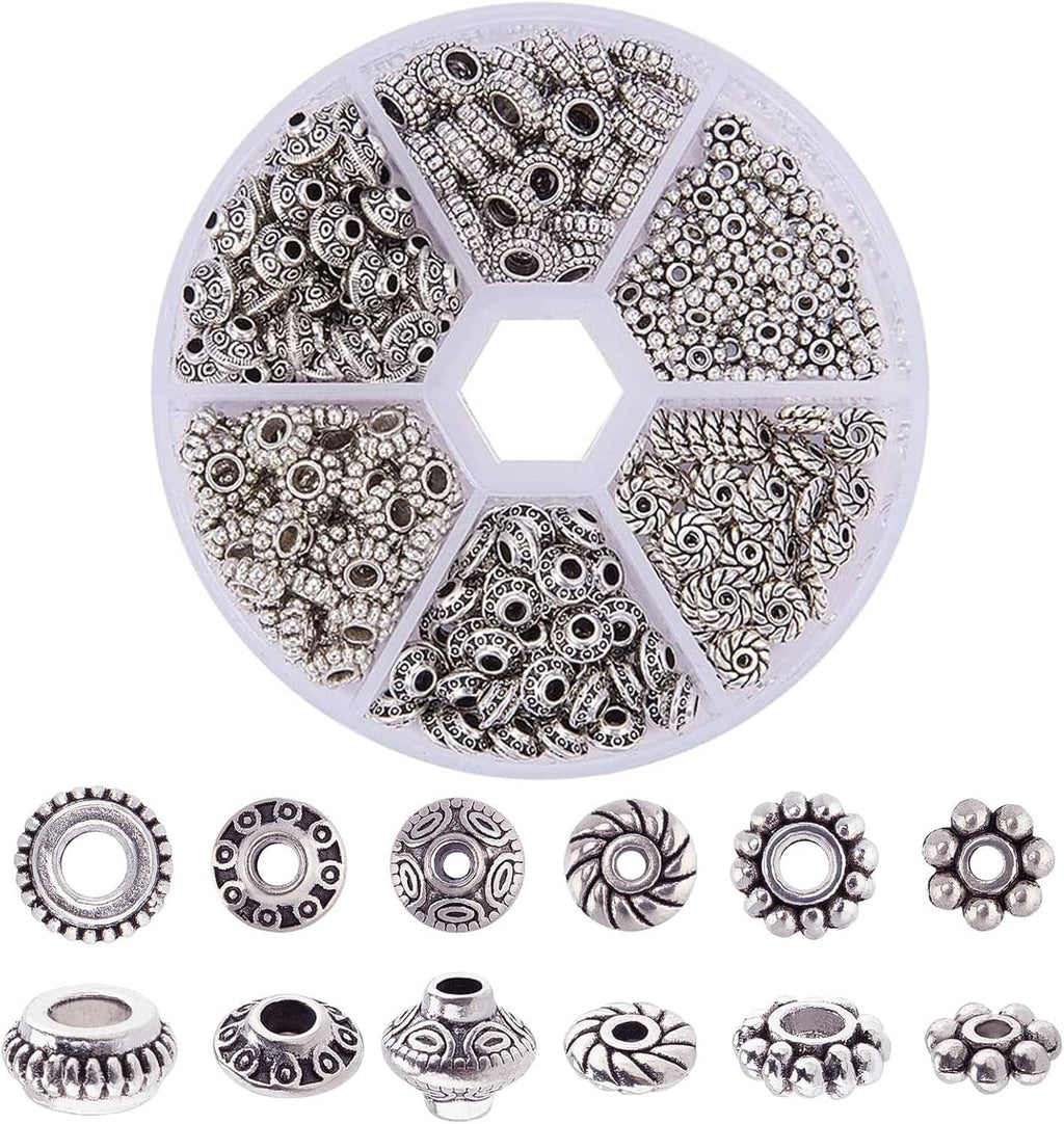 Antique silver tube spacer bead set in a round organizer, with multiple etched designs