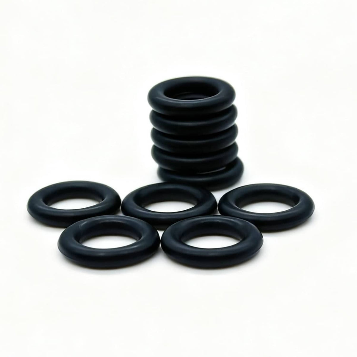 Multiple black rubber O-ring seals arranged flat, compact seal pack