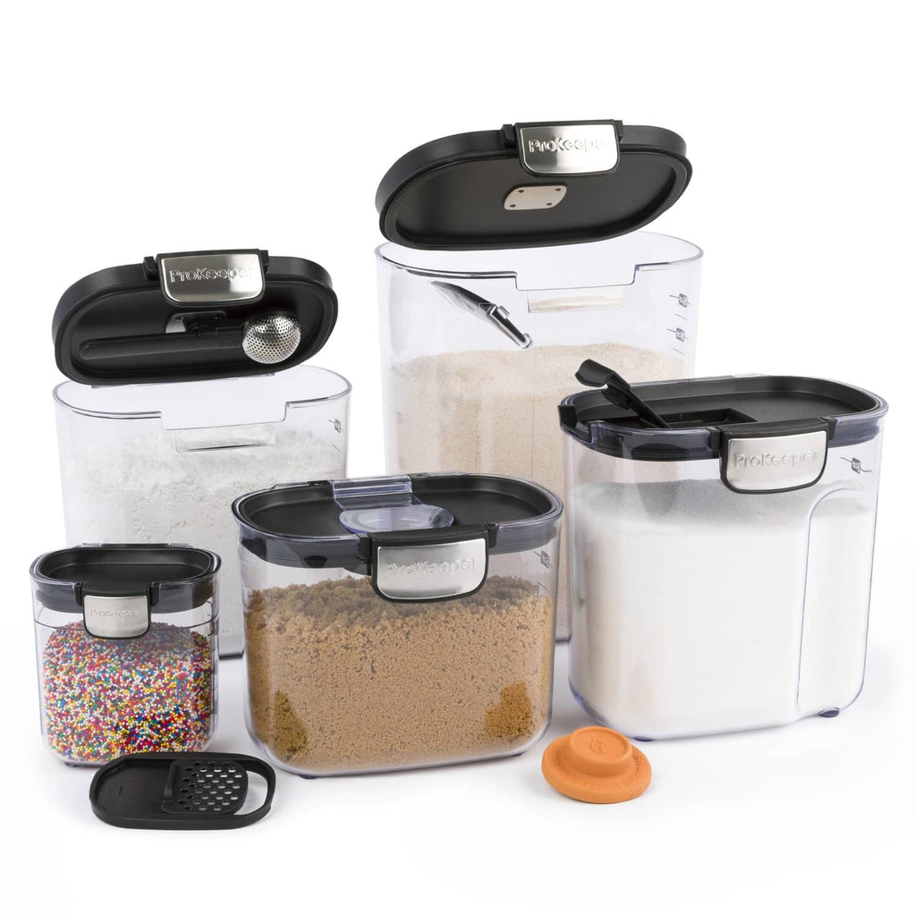 Set of clear airtight food storage containers with black lids and measuring scoop