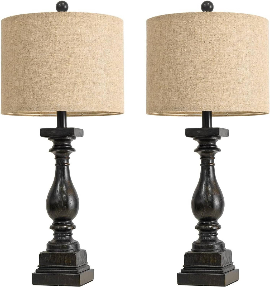 Pair of table lamps with beige drum shades and dark turned black pedestal bases