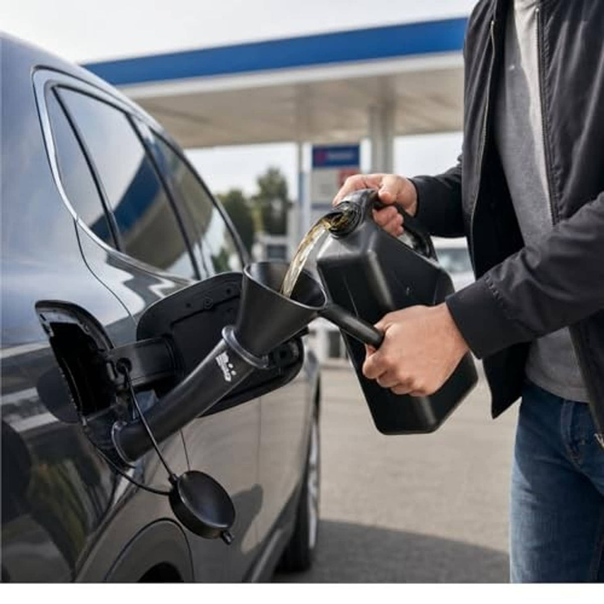 Tethered gas capless dust cover and fuel funnel being fitted at a car fuel port