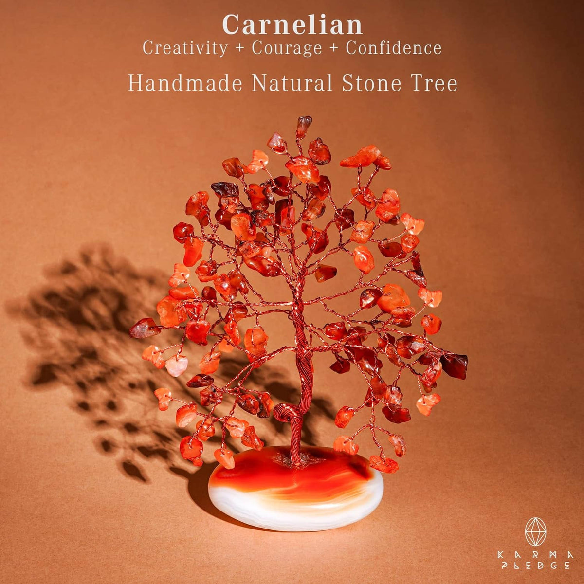 Handmade carnelian natural stone tree with orange-red crystal branches on white base