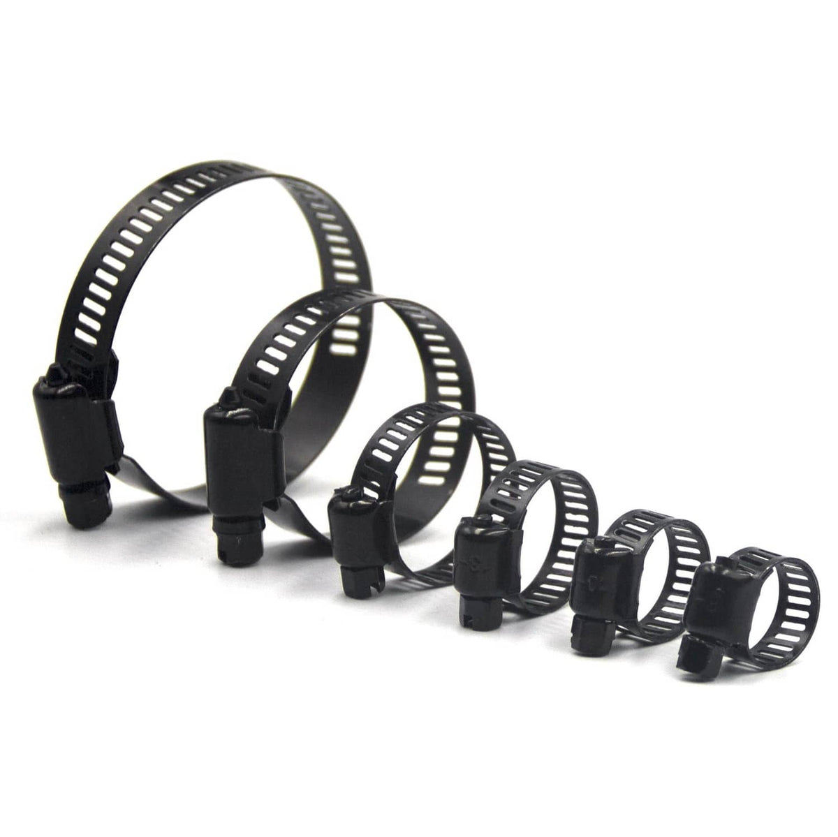 Assorted black worm gear hose clamps laid out, different band diameters