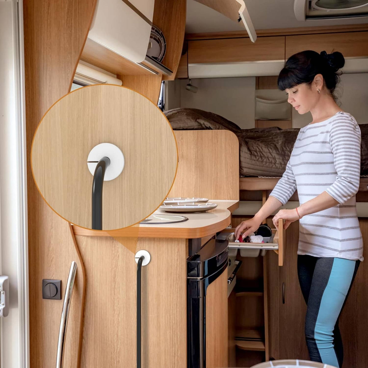 White cable pass-through grommet in cabinet wall, routing a cord behind kitchen cabinetry