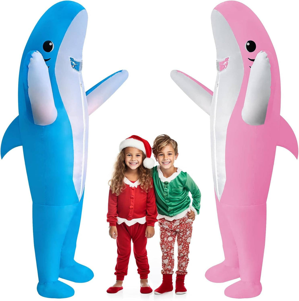 Inflatable blue and pink shark costumes with two children standing between them