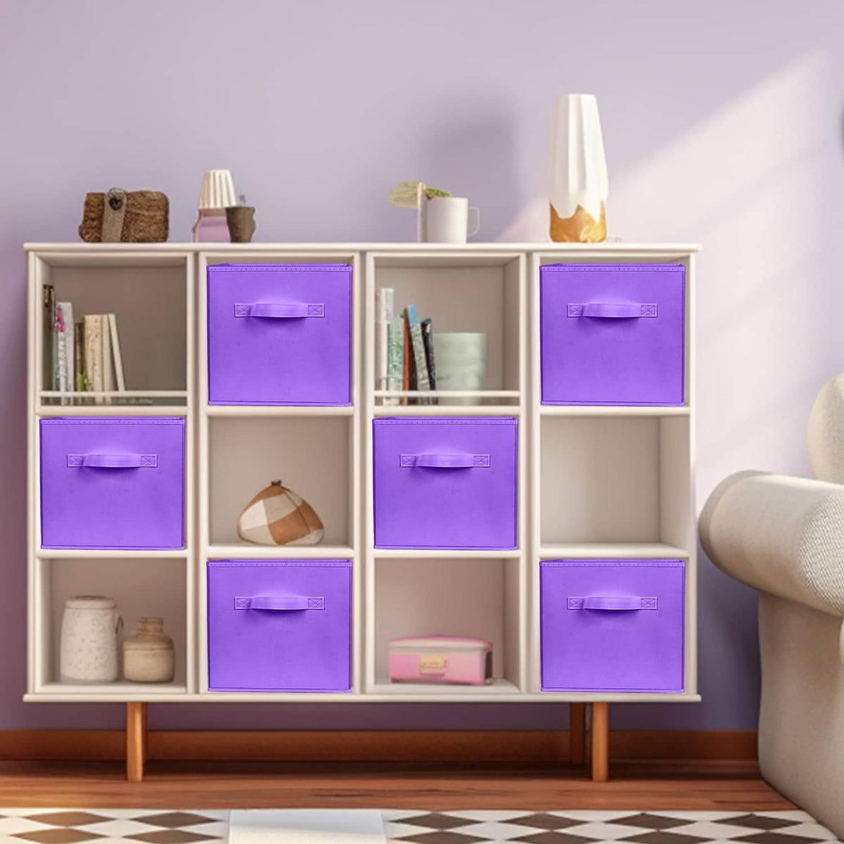 Violet foldable fabric storage cubes with front handles in a cabinet with open bins