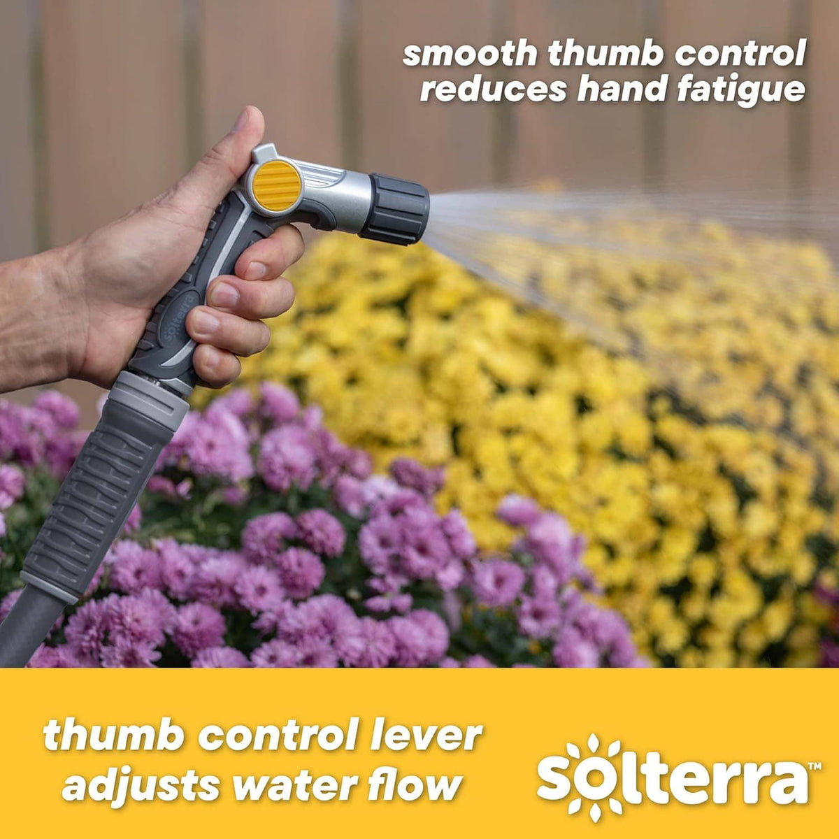 Garden hose nozzle held in hand with thumb control lever and yellow flow dial