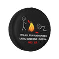 Black round RV spare tire cover with flame graphic and slogan text