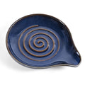 Dark blue ceramic spoon rest with spiral swirl pattern, rounded leaf shape