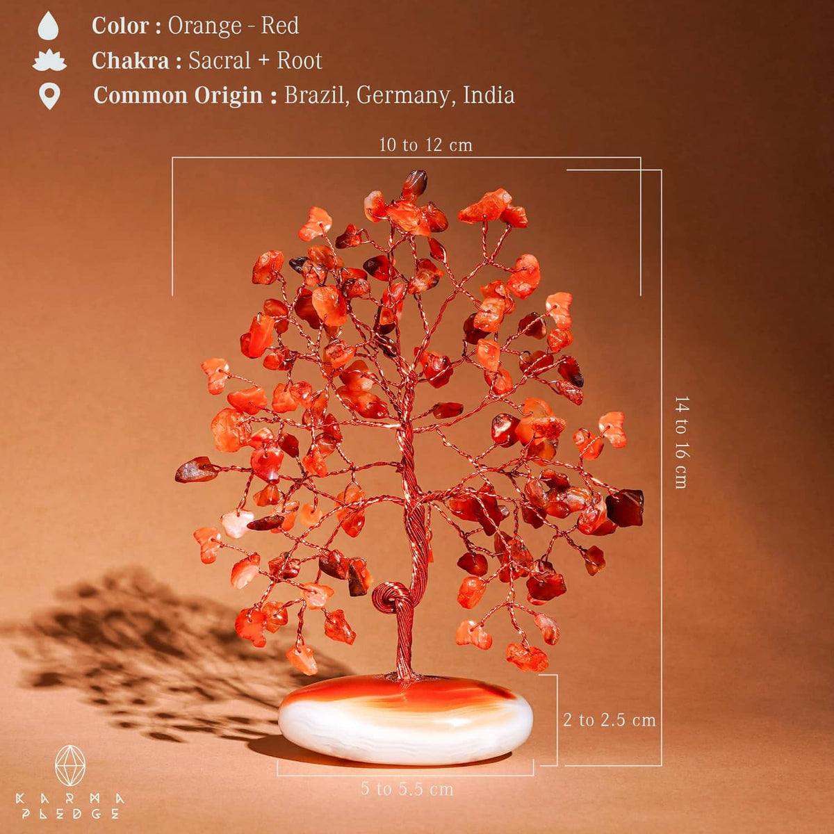 Orange-red carnelian stone tree with wire branches and white palm-stone base