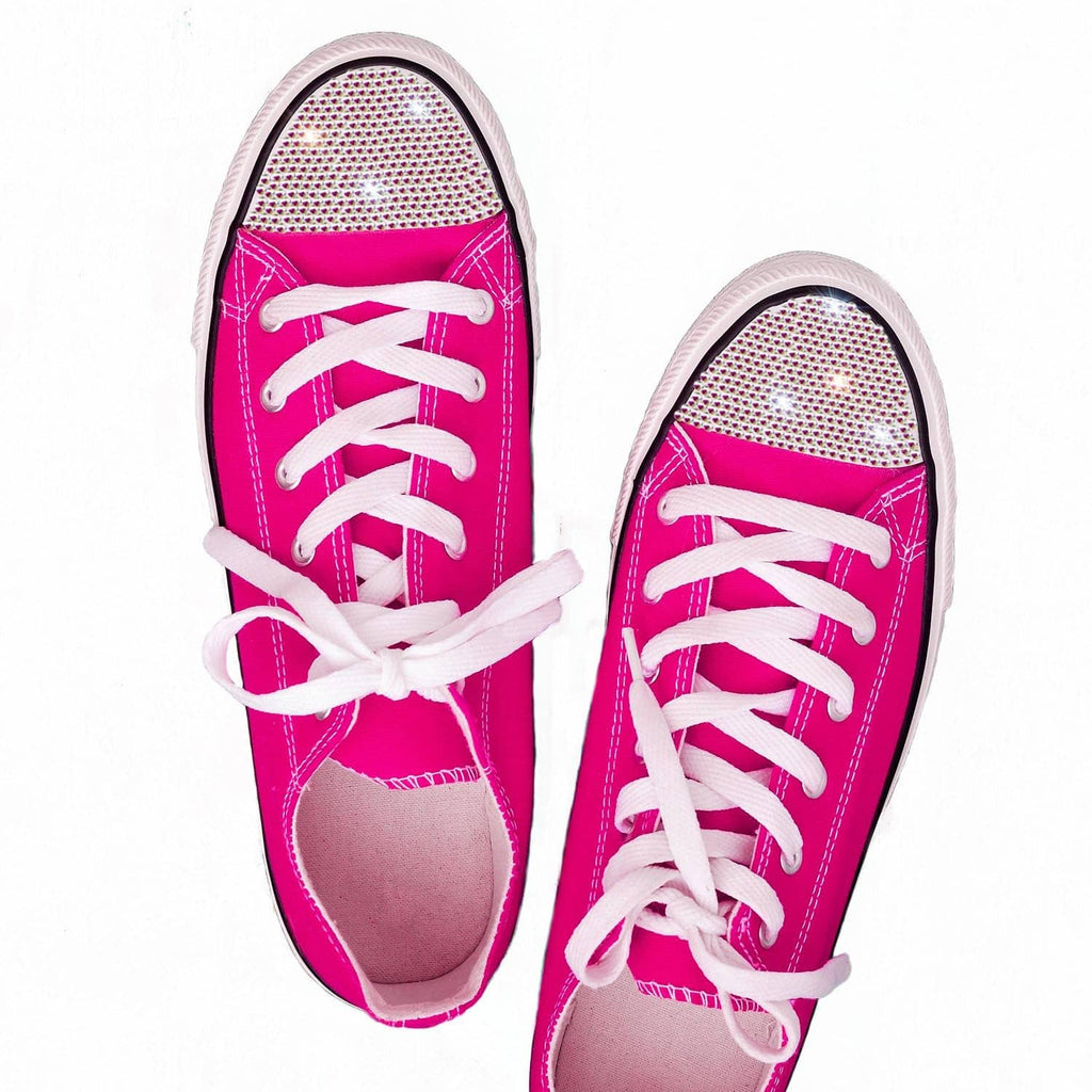 Pink rhinestone canvas sneakers with white laces and glittery panels.