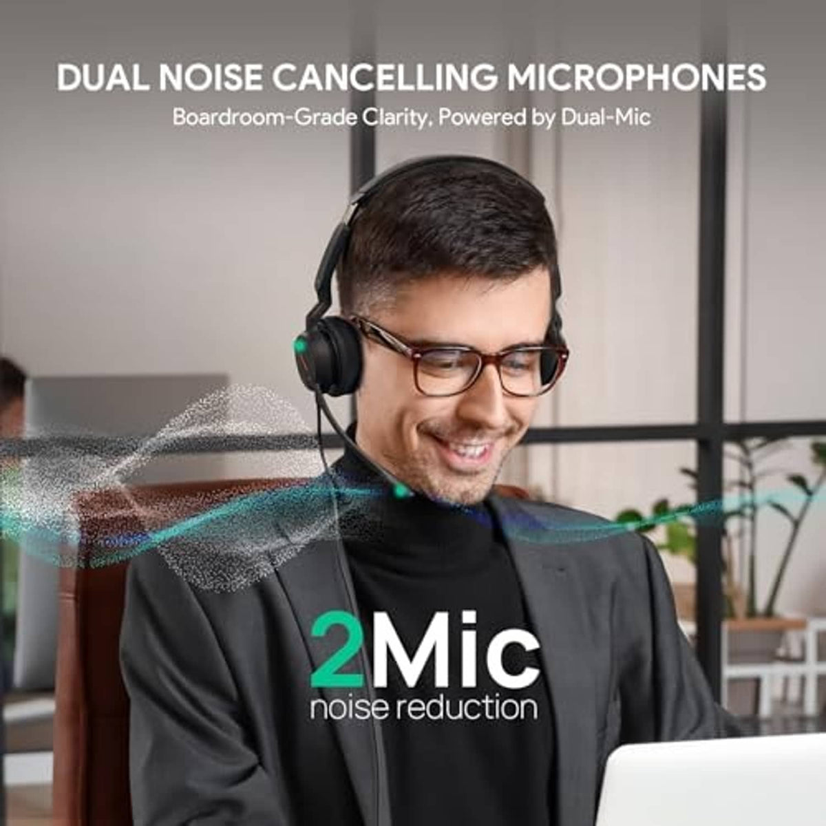 Black wired over-ear headset with boom microphone worn by person at laptop