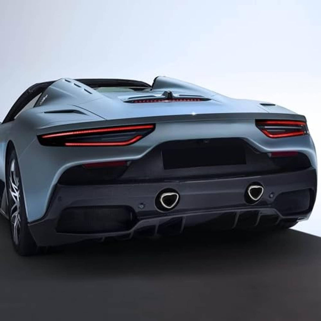 Vehicle rear with stainless steel heart-shaped exhaust tips, polished silver trim and dark outlets.