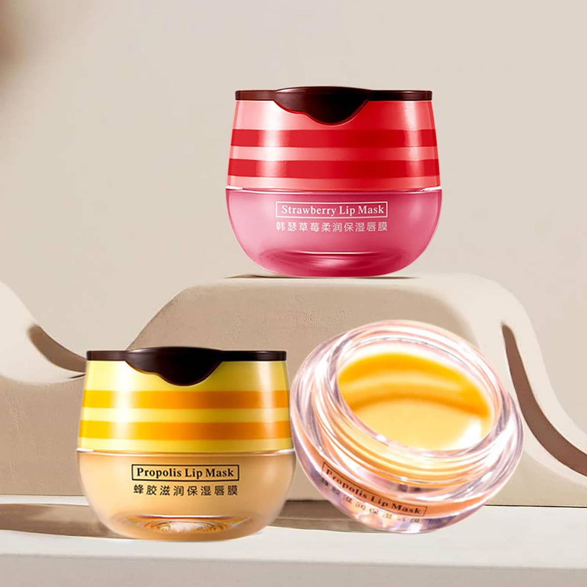 Two lip mask balm jars—strawberry red and propolis yellow—plus open balm container