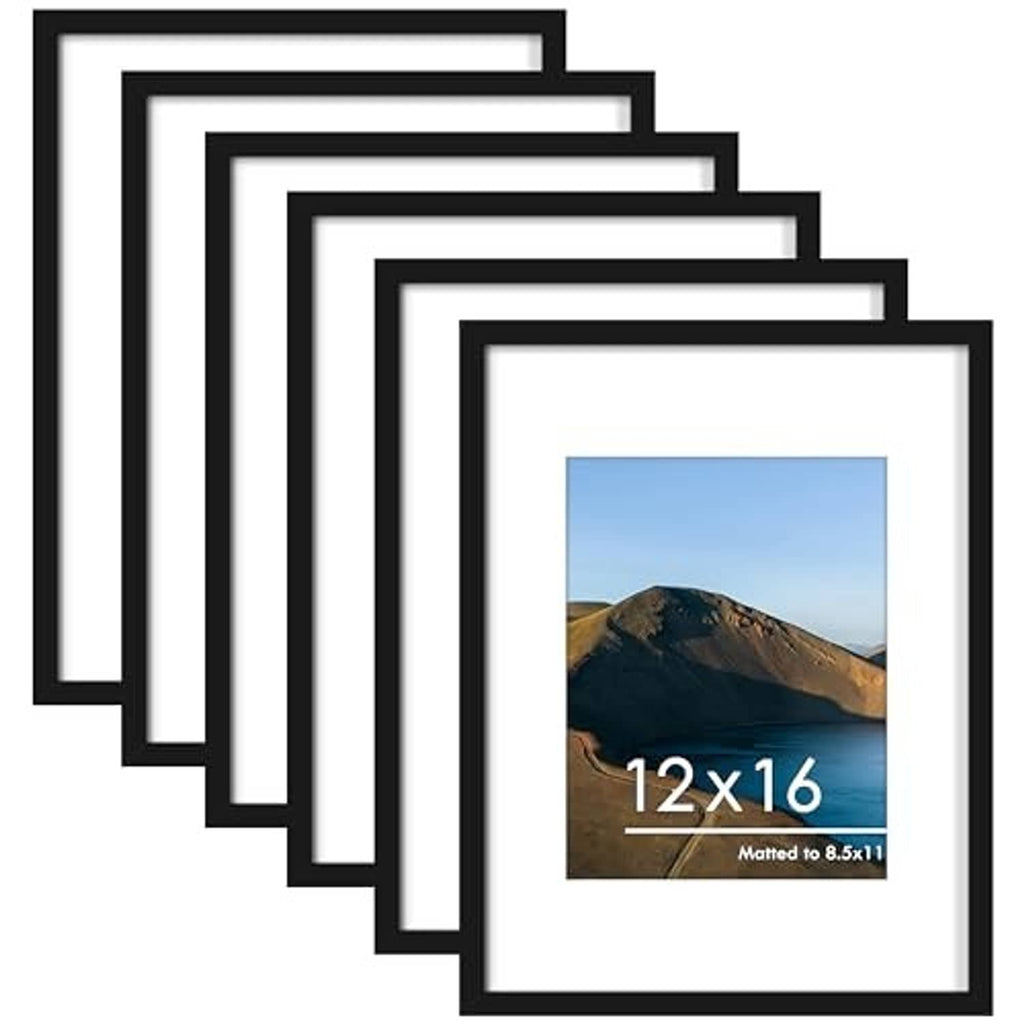 Stack of black picture frames with white mats and landscape photo cards