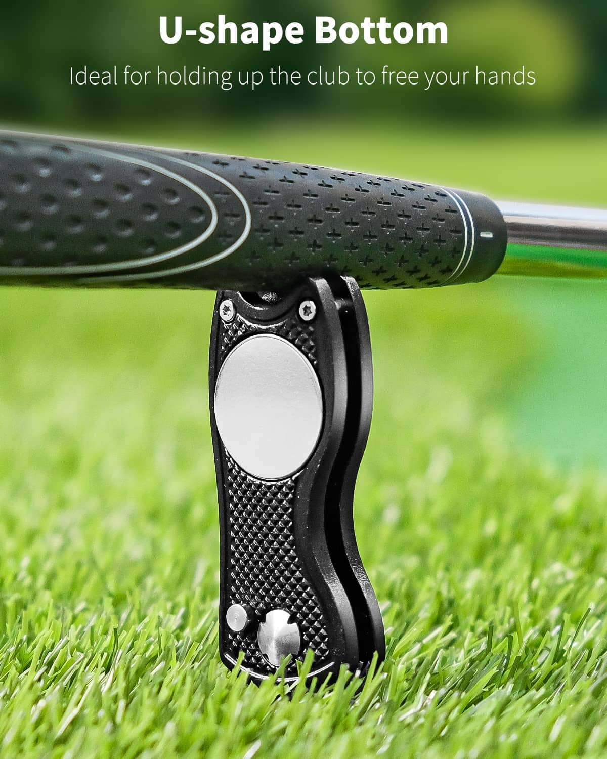 Black textured golf divot repair tool with U-shaped bottom and circular opening