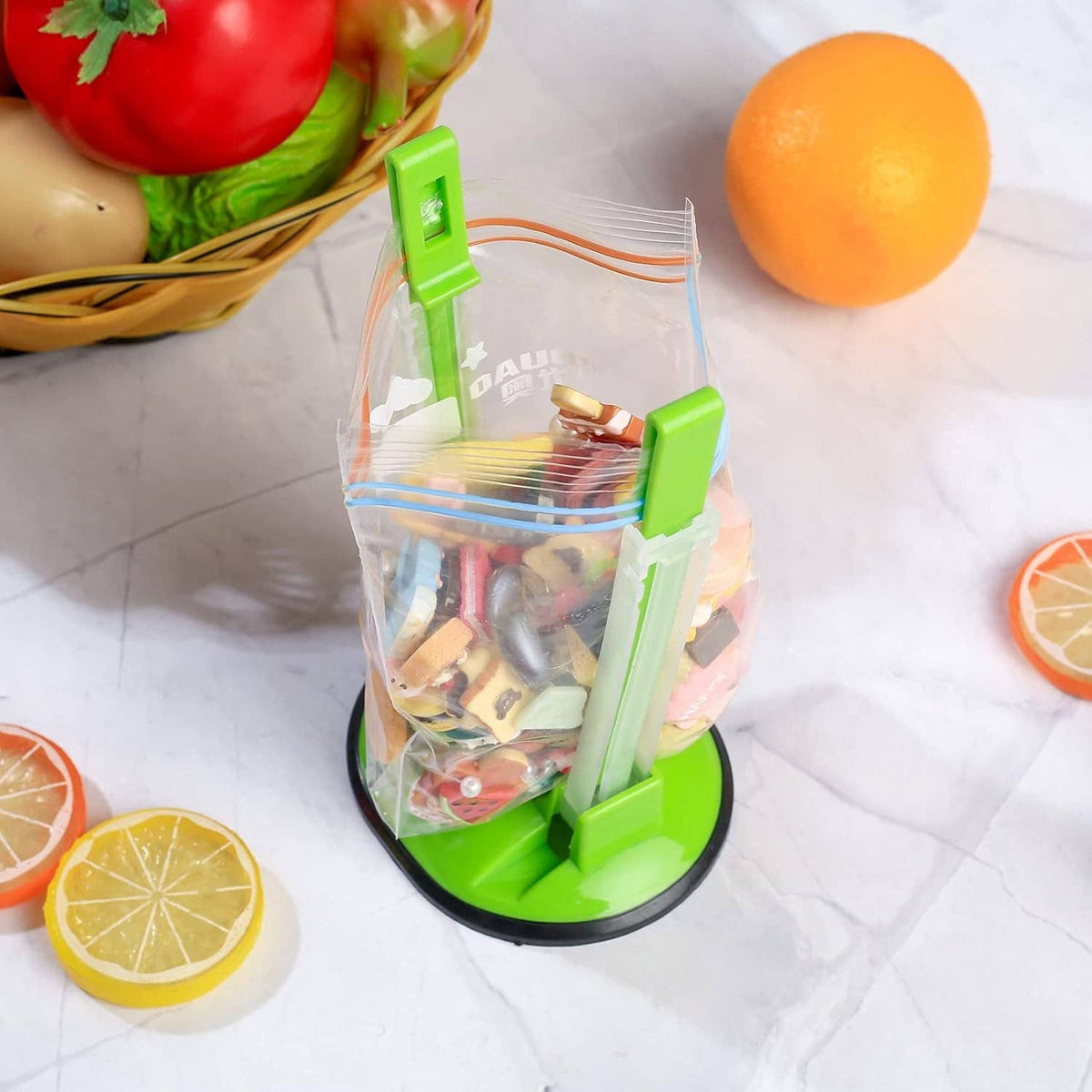 Green and clear freezer bag holder stand with clips, keeping a bag upright for storage