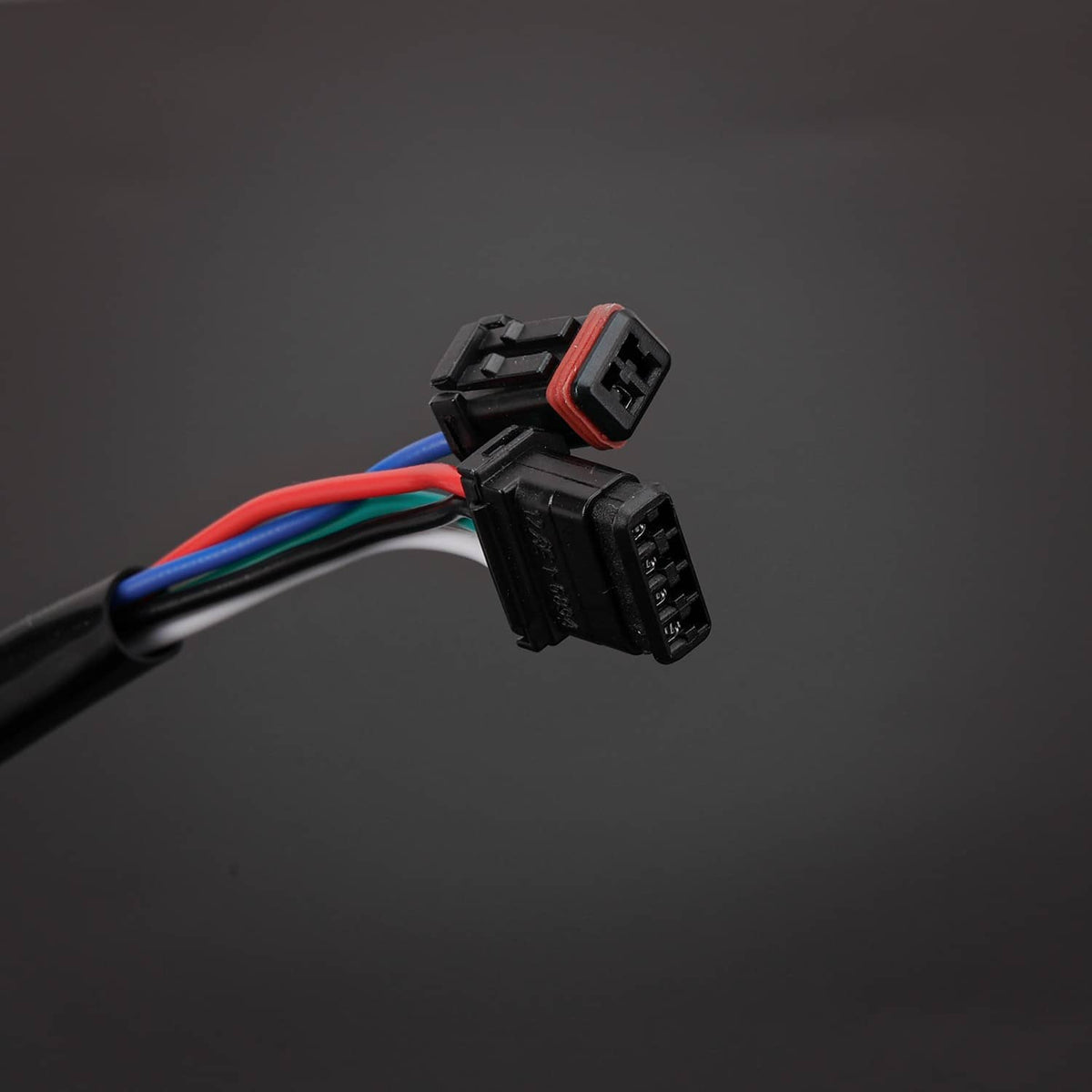 Black wiring connector with colored leads on glossy handlebar
