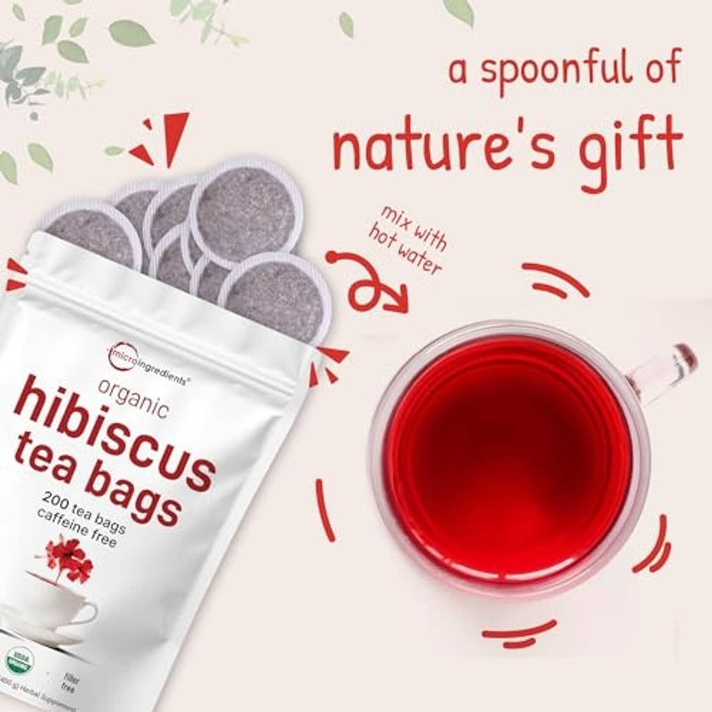Organic hibiscus tea bags pouch with cup of red brewed tea and leaf accents