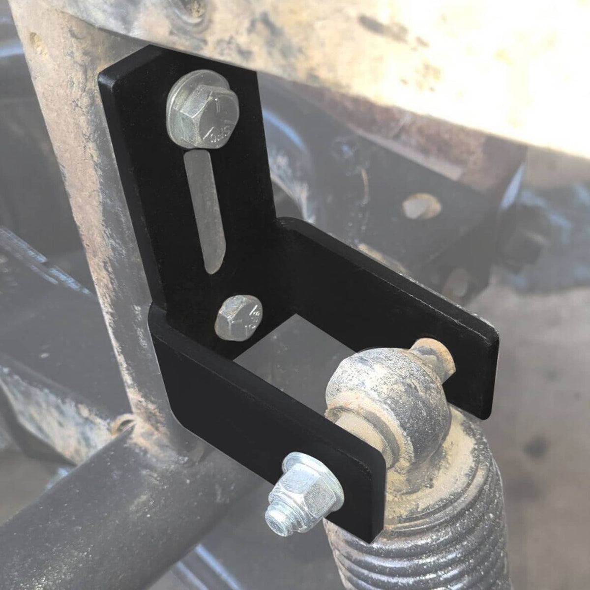 Lift bracket installed on golf cart frame with black steel block and hardware