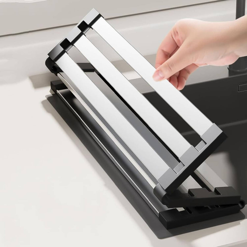 Roll-up dish drying rack being folded, showing silver slats and black end frame