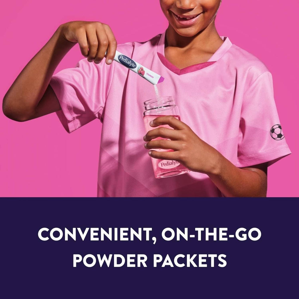 Child holding an electrolyte powder packet with a drink cup, on-the-go